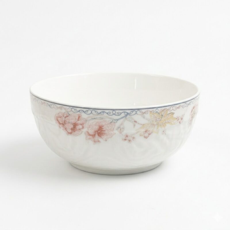 Bol din ceramică albă cu motive florale delicate și margini decorative, ideal pentru servirea mesei.