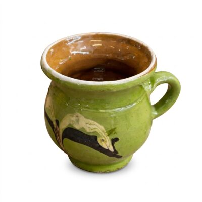 Cană din ceramică tradițională de culoare verde, pictată manual cu motive decorative.